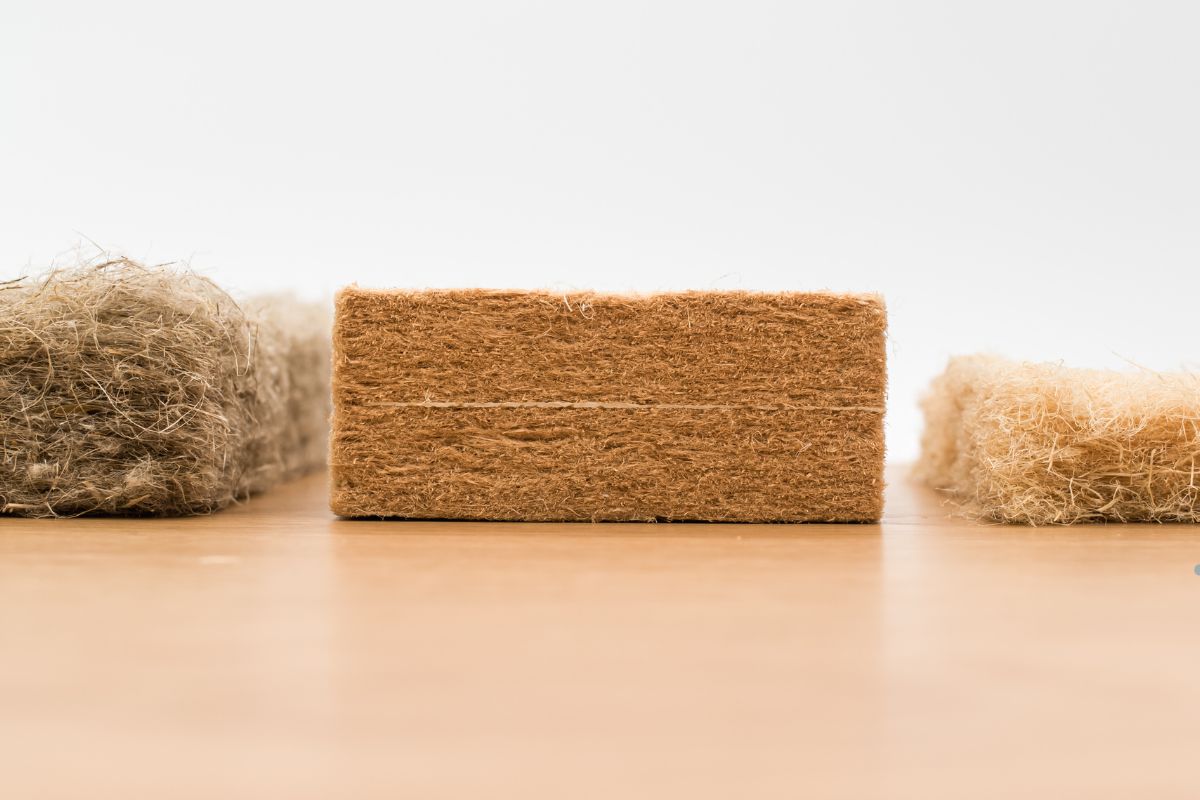 A block of wood topped with a piece of wool, representing insulation materials for an insulation service.